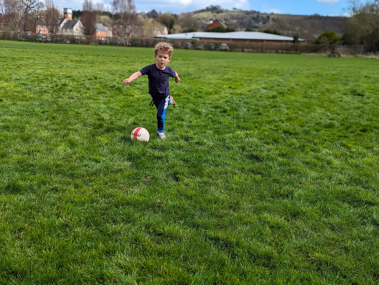 Young football players on a grassy pitch
